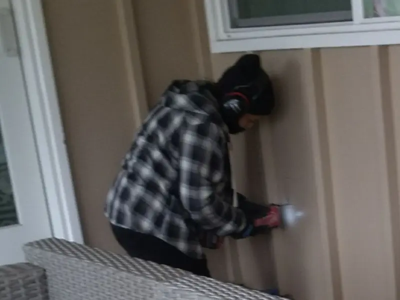 Professional electrician installing an exterior outlet in Greenbrier